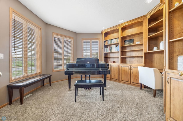 sitting room with baseboards, recessed lighting, and light carpet