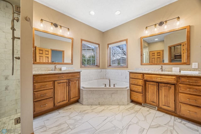 bathroom with a sink, two vanities, a bath, and marble finish floor