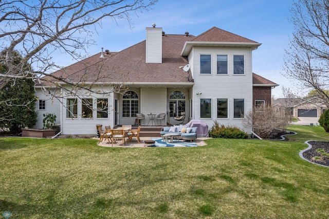 back of house with a lawn, a chimney, an outdoor living space, and a patio area