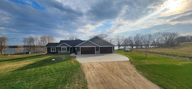 17292 Boyer Lake Rd, Lake Park, MN 56554 - view of front facade featuring a garage, a front lawn, stone siding, and concrete driveway