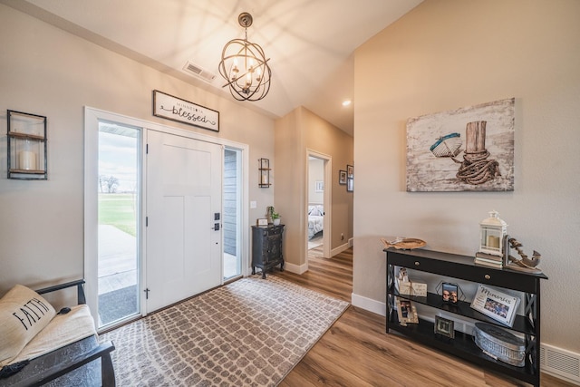 17292 Boyer Lake Rd, Lake Park, MN 56554 - entrance foyer with an inviting chandelier, baseboards, wood finished floors, vaulted ceiling, and visible vents
