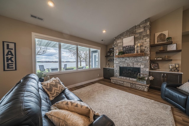 17292 Boyer Lake Rd, Lake Park, MN 56554 - living room with visible vents, a fireplace, baseboards, dark wood-style floors, and vaulted ceiling