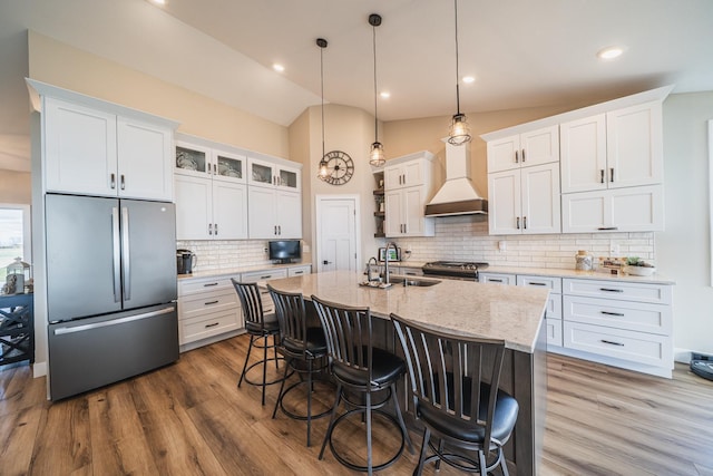 17292 Boyer Lake Rd, Lake Park, MN 56554 - kitchen featuring custom exhaust hood, an island with sink, a breakfast bar area, a sink, and stainless steel appliances