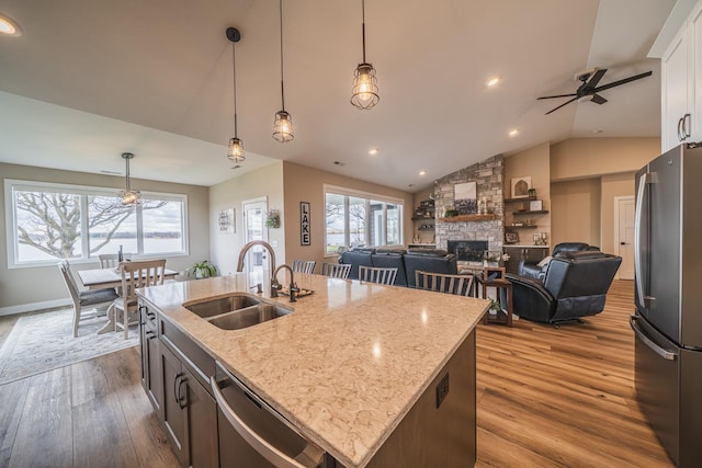 17292 Boyer Lake Rd, Lake Park, MN 56554 - kitchen featuring decorative light fixtures, a fireplace, a sink, stainless steel appliances, and dark wood-type flooring