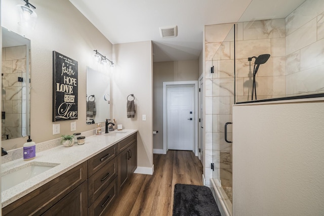 17292 Boyer Lake Rd, Lake Park, MN 56554 - bathroom with a sink, a stall shower, wood finished floors, and visible vents