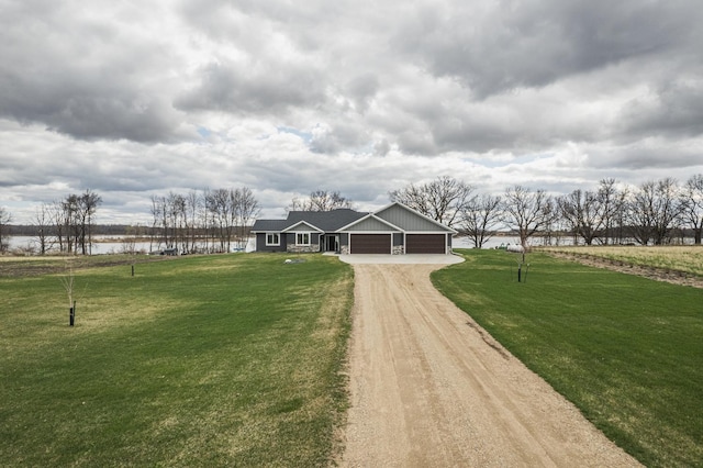 17292 Boyer Lake Rd, Lake Park, MN 56554 - view of front of property featuring dirt driveway, a water view, a front lawn, and a garage