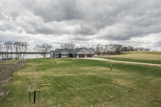17292 Boyer Lake Rd, Lake Park, MN 56554 - exterior space featuring concrete driveway, a water view, an attached garage, and a yard