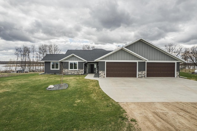 17292 Boyer Lake Rd, Lake Park, MN 56554 - view of front of property with a garage, a front lawn, stone siding, board and batten siding, and concrete driveway
