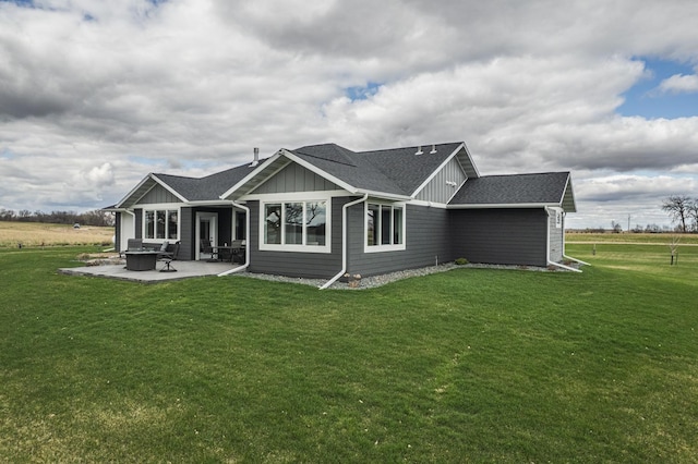 17292 Boyer Lake Rd, Lake Park, MN 56554 - rear view of property featuring roof with shingles, a patio, board and batten siding, and a yard