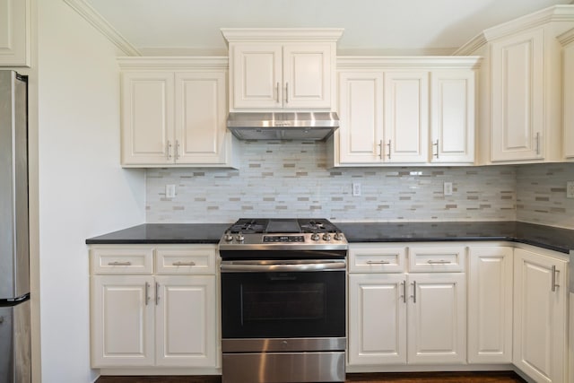 kitchen featuring dark countertops, appliances with stainless steel finishes, backsplash, and under cabinet range hood