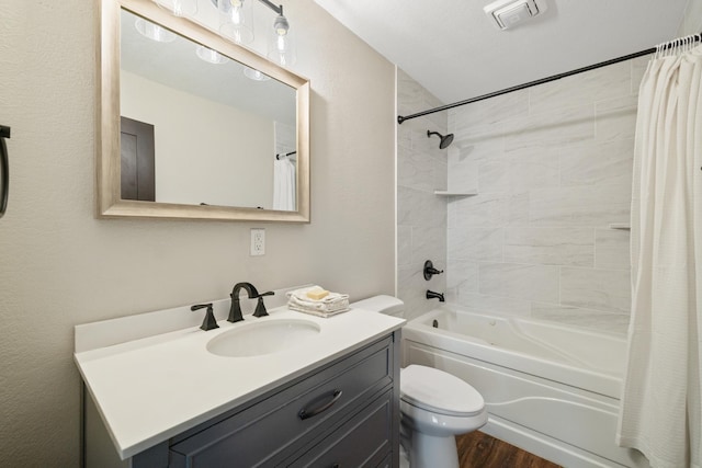 full bathroom with vanity, shower / tub combo with curtain, wood finished floors, and toilet