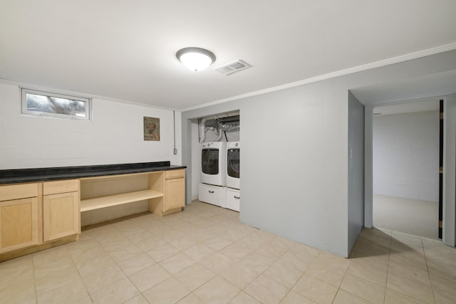 interior space featuring crown molding, visible vents, laundry area, and washer and dryer