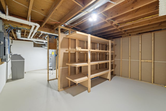 unfinished basement featuring water heater