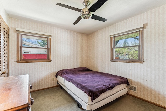 bedroom featuring carpet floors, visible vents, and multiple windows