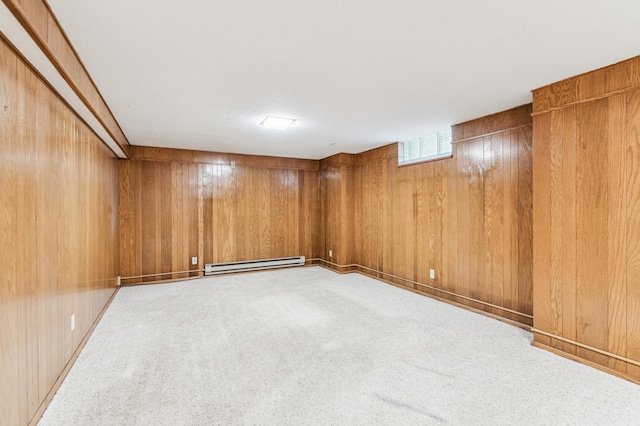 basement featuring wooden walls, a baseboard radiator, and carpet flooring