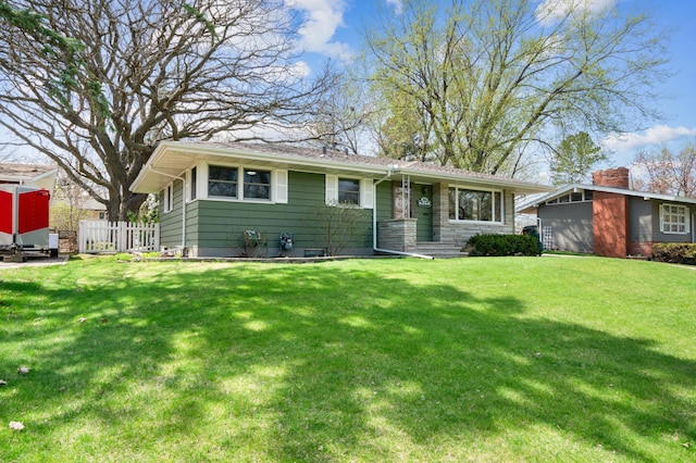 single story home featuring fence and a front lawn