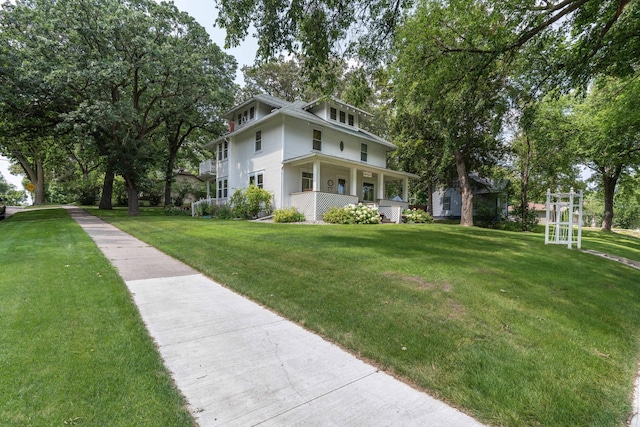 view of side of property featuring a porch and a yard