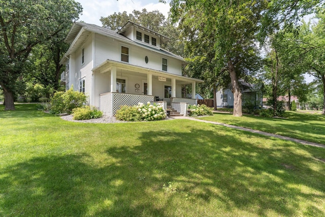 traditional style home with covered porch and a front lawn