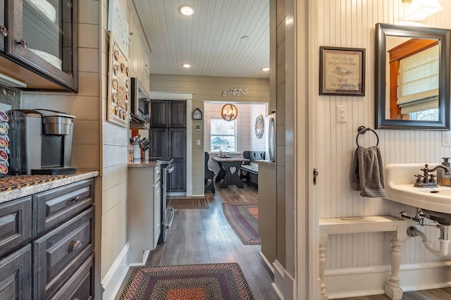 corridor featuring recessed lighting, wood walls, dark wood-style floors, and wood ceiling
