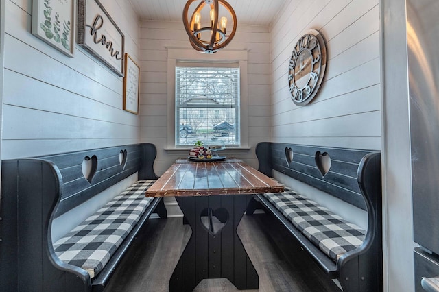 interior space with a chandelier and wooden walls