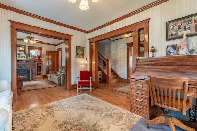 office area with ornamental molding, ceiling fan, and wood finished floors