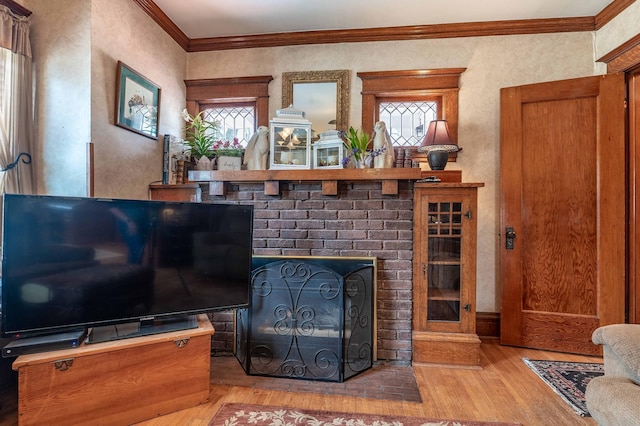 living area with plenty of natural light, ornamental molding, a textured wall, and hardwood / wood-style floors
