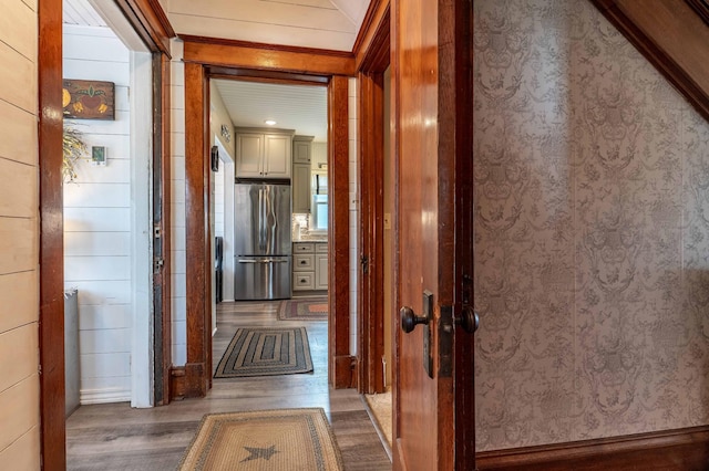hall featuring ornamental molding and wood finished floors