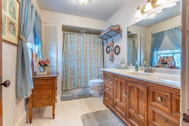 full bathroom with toilet, curtained shower, and vanity