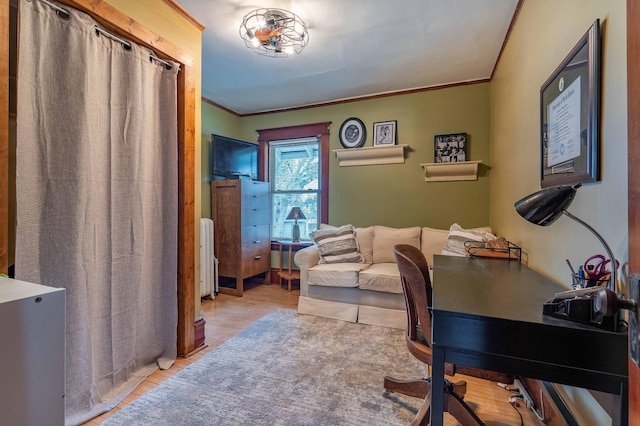 home office featuring crown molding, radiator, and wood finished floors