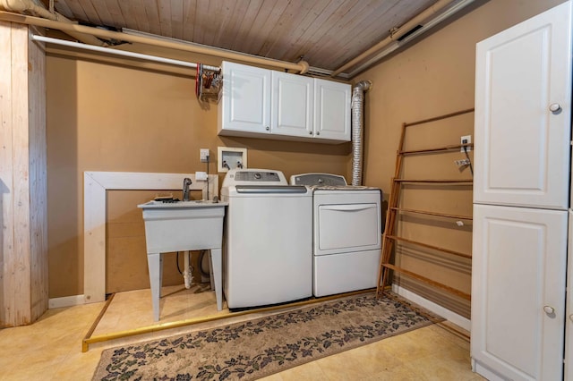 clothes washing area with cabinet space, washing machine and dryer, light tile patterned flooring, and wooden ceiling