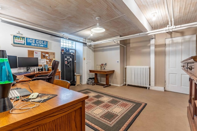 office featuring baseboards, finished concrete flooring, and radiator heating unit