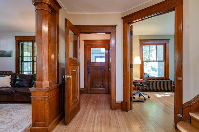 1043 Lincoln Ave, Saint Paul, MN 55105 - foyer with radiator heating unit, decorative columns, and light wood finished floors