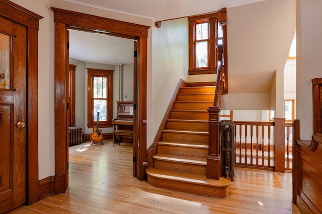 1043 Lincoln Ave, Saint Paul, MN 55105 - stairway featuring wood-type flooring, radiator heating unit, and baseboards