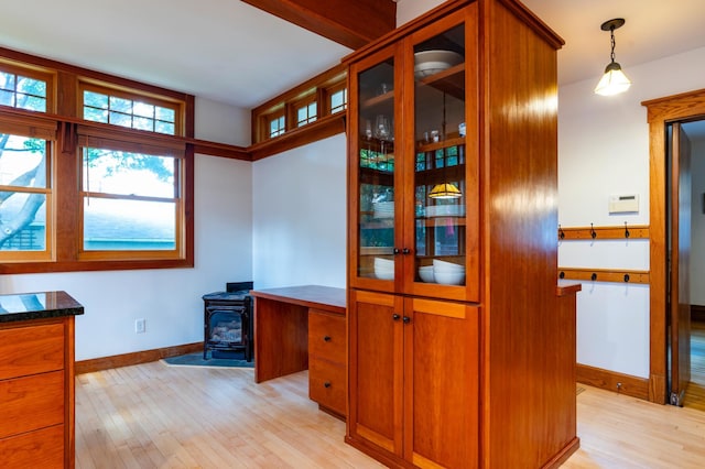 1043 Lincoln Ave, Saint Paul, MN 55105 - office area with light wood-style flooring, a wood stove, and baseboards