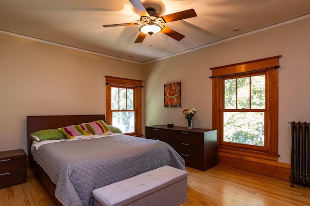 1043 Lincoln Ave, Saint Paul, MN 55105 - bedroom featuring radiator heating unit, light wood-style flooring, crown molding, and a ceiling fan