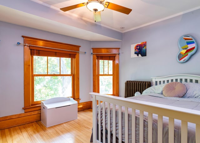1043 Lincoln Ave, Saint Paul, MN 55105 - bedroom featuring light wood-style floors, ornamental molding, radiator, and a ceiling fan