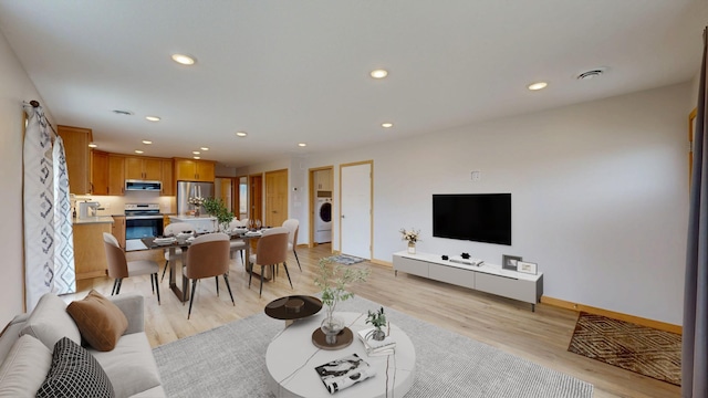400 Alfred Ct SW, Eyota, MN 55934 - living area with washer / clothes dryer, recessed lighting, light wood finished floors, and baseboards