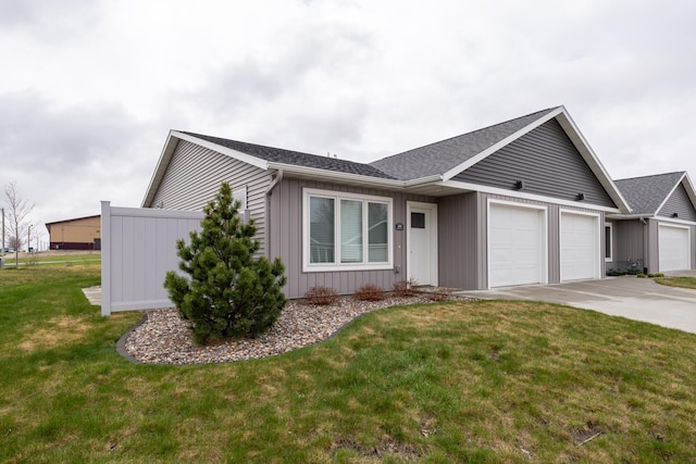 400 Alfred Ct SW, Eyota, MN 55934 - single story home with a garage, concrete driveway, board and batten siding, a front yard, and a shingled roof
