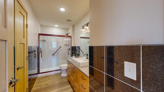 400 Alfred Ct SW, Eyota, MN 55934 - bathroom featuring toilet, a shower stall, vanity, wood finished floors, and recessed lighting