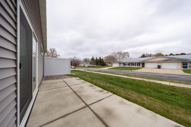 400 Alfred Ct SW, Eyota, MN 55934 - view of patio / terrace with a garage and a residential view