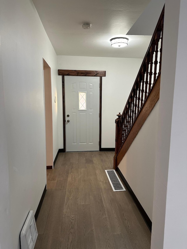15 1st St SE, Melrose, MN 56352 - doorway to outside with stairs, baseboards, visible vents, and dark wood-style floors