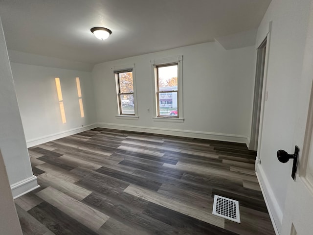 15 1st St SE, Melrose, MN 56352 - spare room featuring baseboards, dark wood finished floors, and visible vents