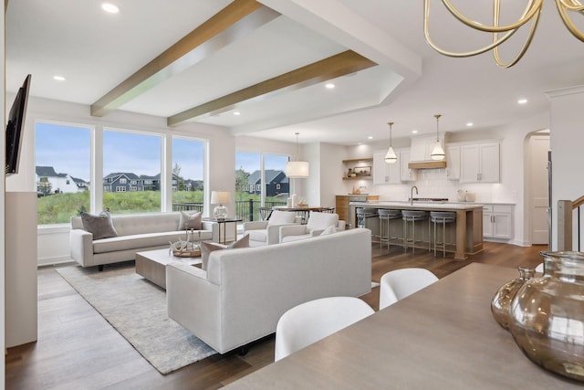 living area with arched walkways, recessed lighting, and dark wood-type flooring