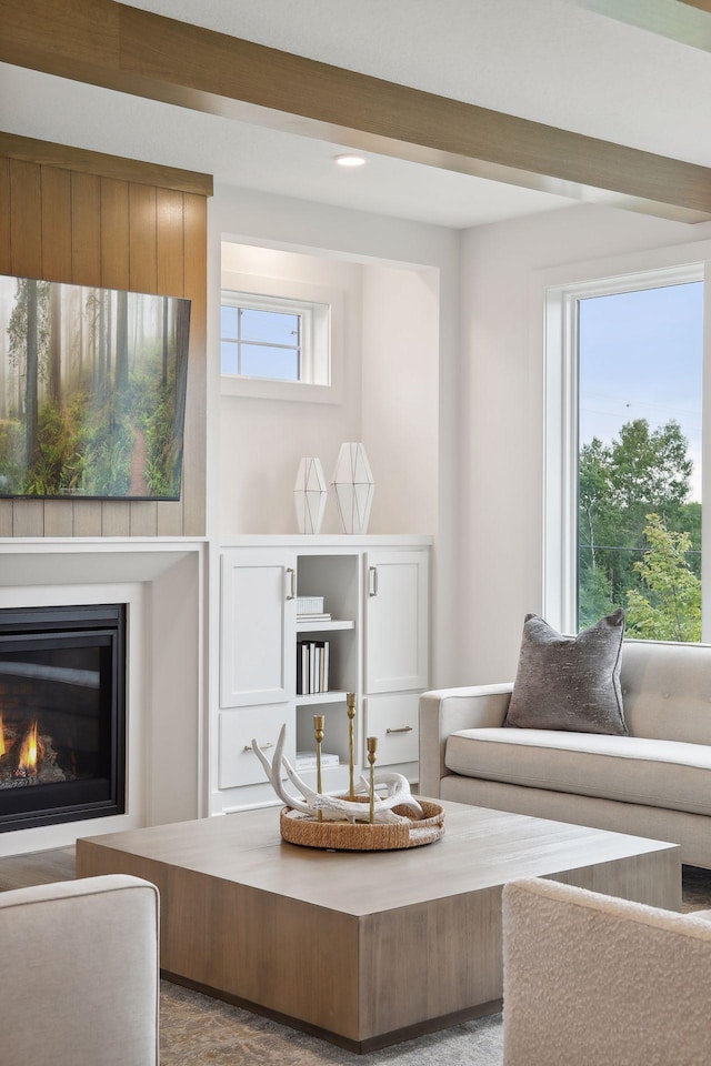 sitting room featuring recessed lighting and a glass covered fireplace