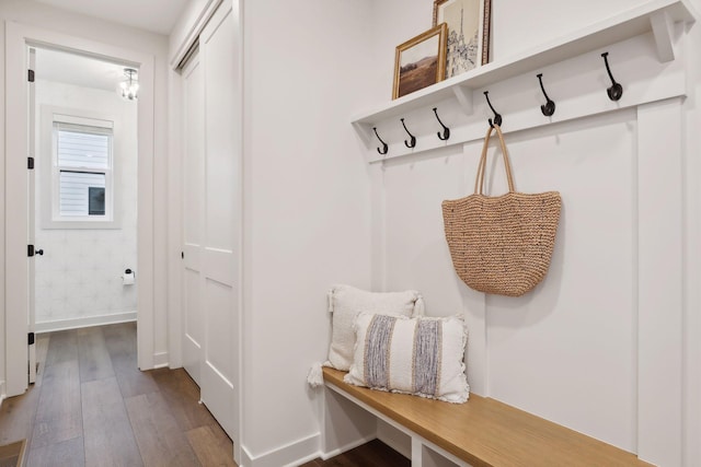 mudroom with dark wood-type flooring and baseboards
