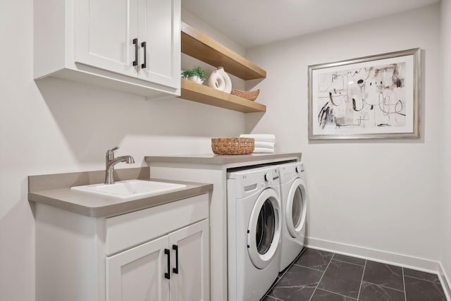 laundry area with cabinet space, a sink, separate washer and dryer, marble finish floor, and baseboards