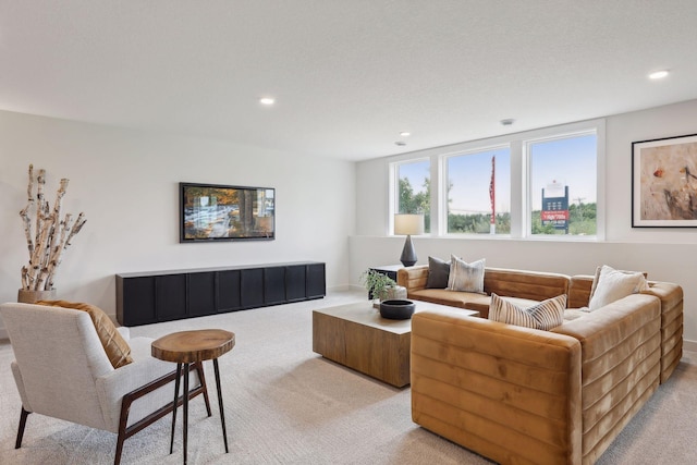 living area featuring recessed lighting and light carpet