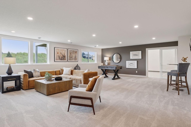 living area with baseboards, light carpet, and recessed lighting