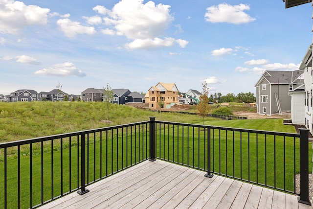wooden deck with a yard and a residential view
