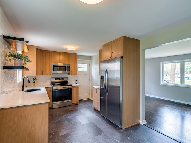 kitchen featuring open shelves, light countertops, tasteful backsplash, a sink, and stainless steel appliances
